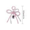 A pink pearl bowknot keychain featuring a heart pendant and strung pearls on a silver-colored ring.
