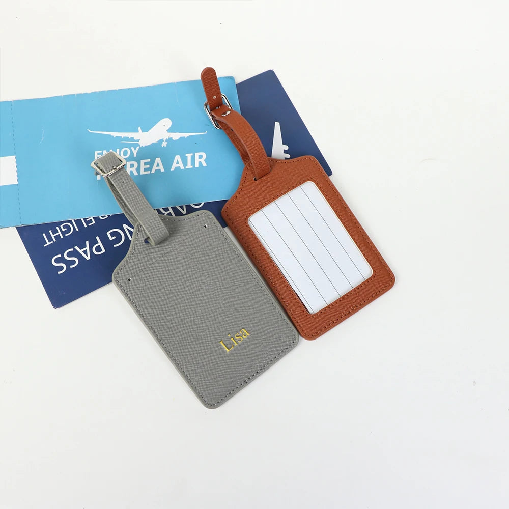 A set of two custom PU leather luggage tags, one gray and one brown, with a white rectangular detail.