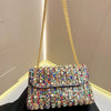 A gold chain strap luxury rhinestone evening clutch bag with multicolored stones.