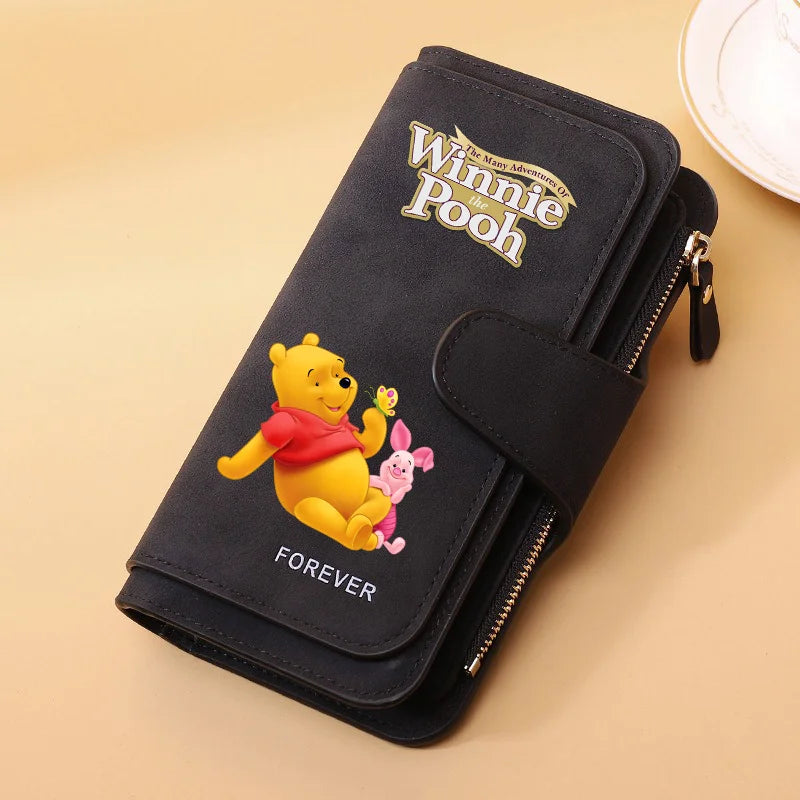 A black zippered pouch featuring a Winnie the Pooh design with the word Forever.