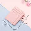 A pink PU leather card holder wallet with a zipper and keychain is shown on a light blue background.