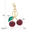 Gold-toned crystal cherry fruit keychain with a green leaf detail