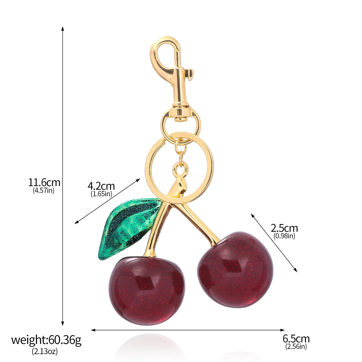 Gold-toned crystal cherry fruit keychain with a green leaf detail