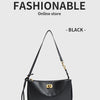 A black leather shoulder tote bag with a gold-toned chain strap displayed against a light gray background.