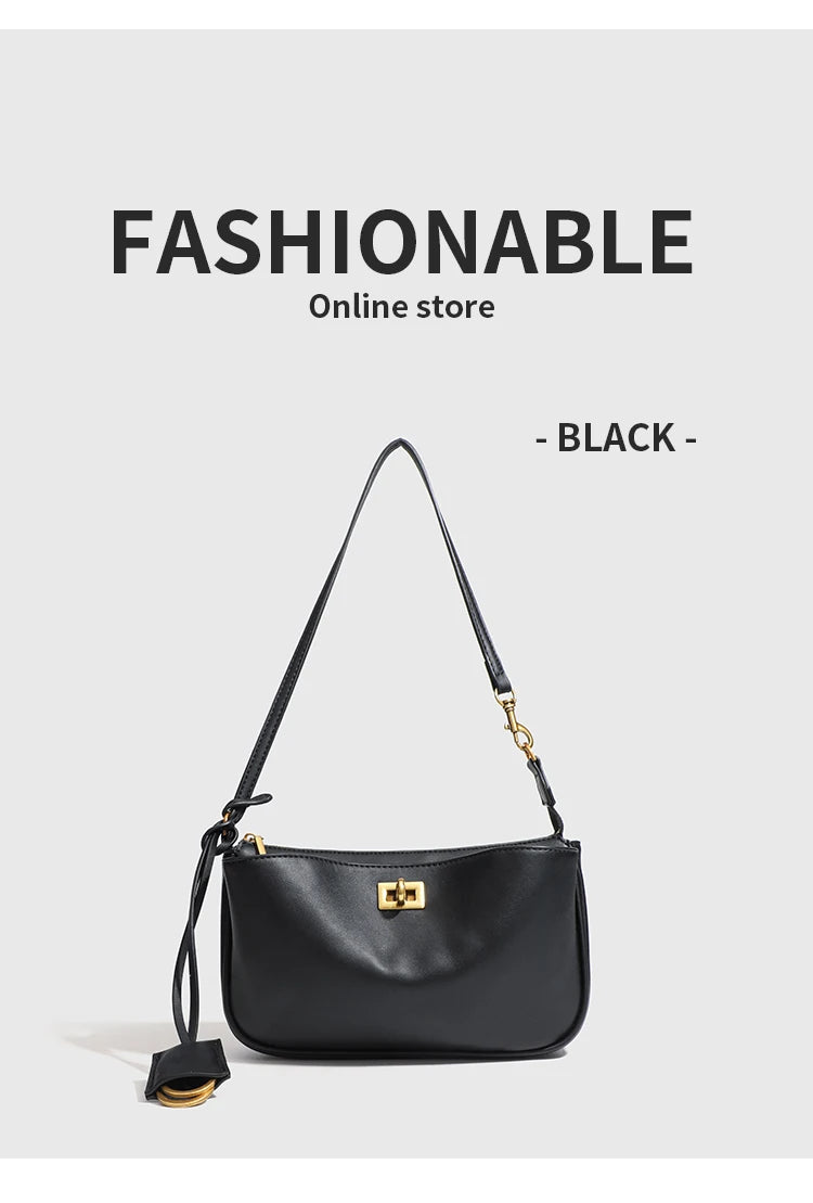 A black leather shoulder tote bag with a gold-toned chain strap displayed against a light gray background.