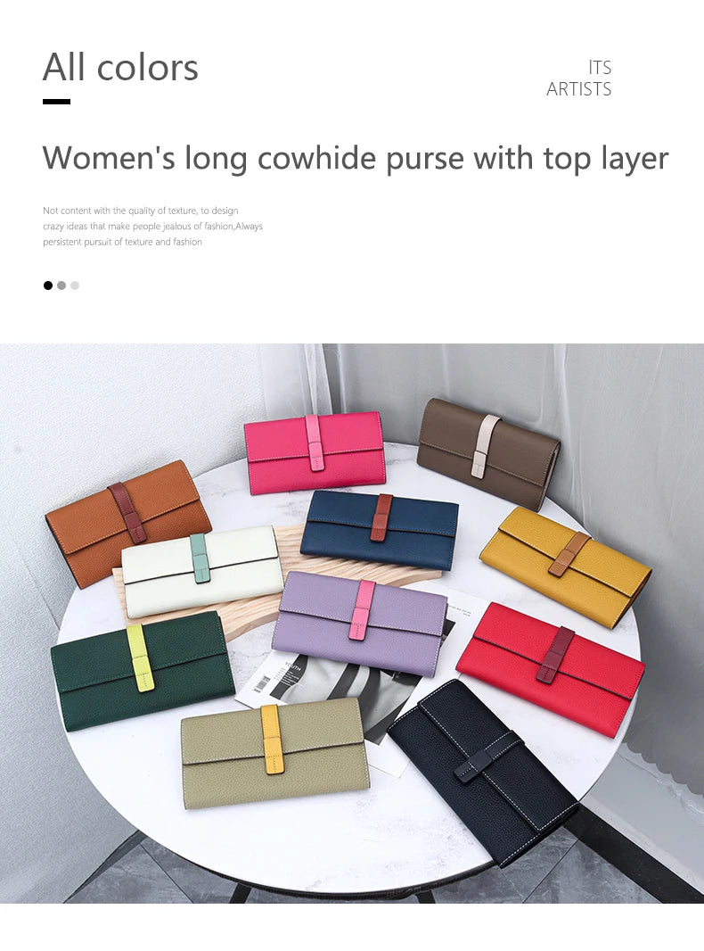 A collection of women's long cowhide purses in various colors and styles displayed on a white table.