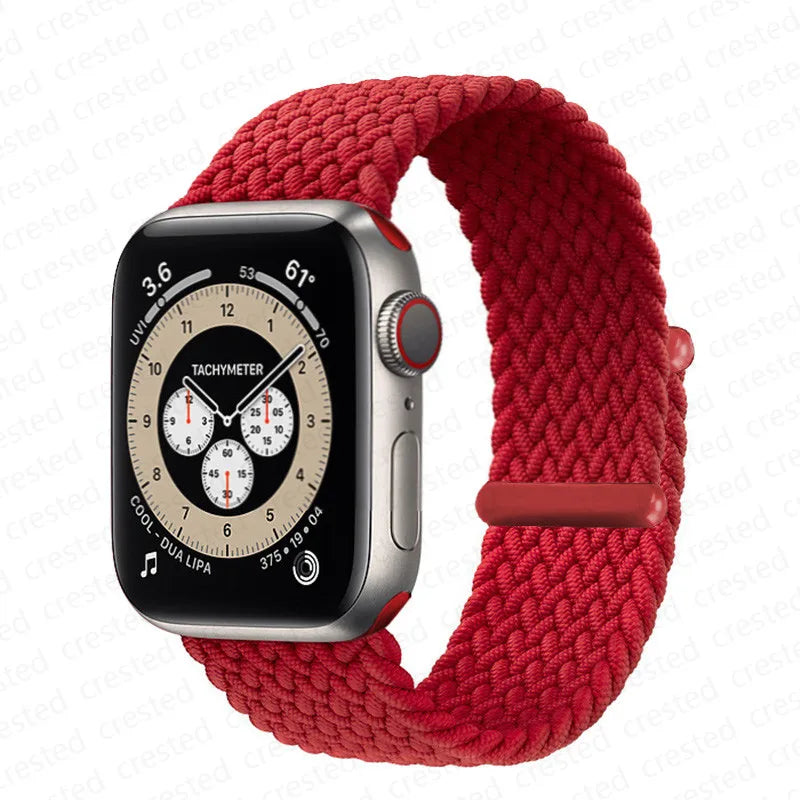 A red braided solo loop stretch band is shown next to an Apple Watch.