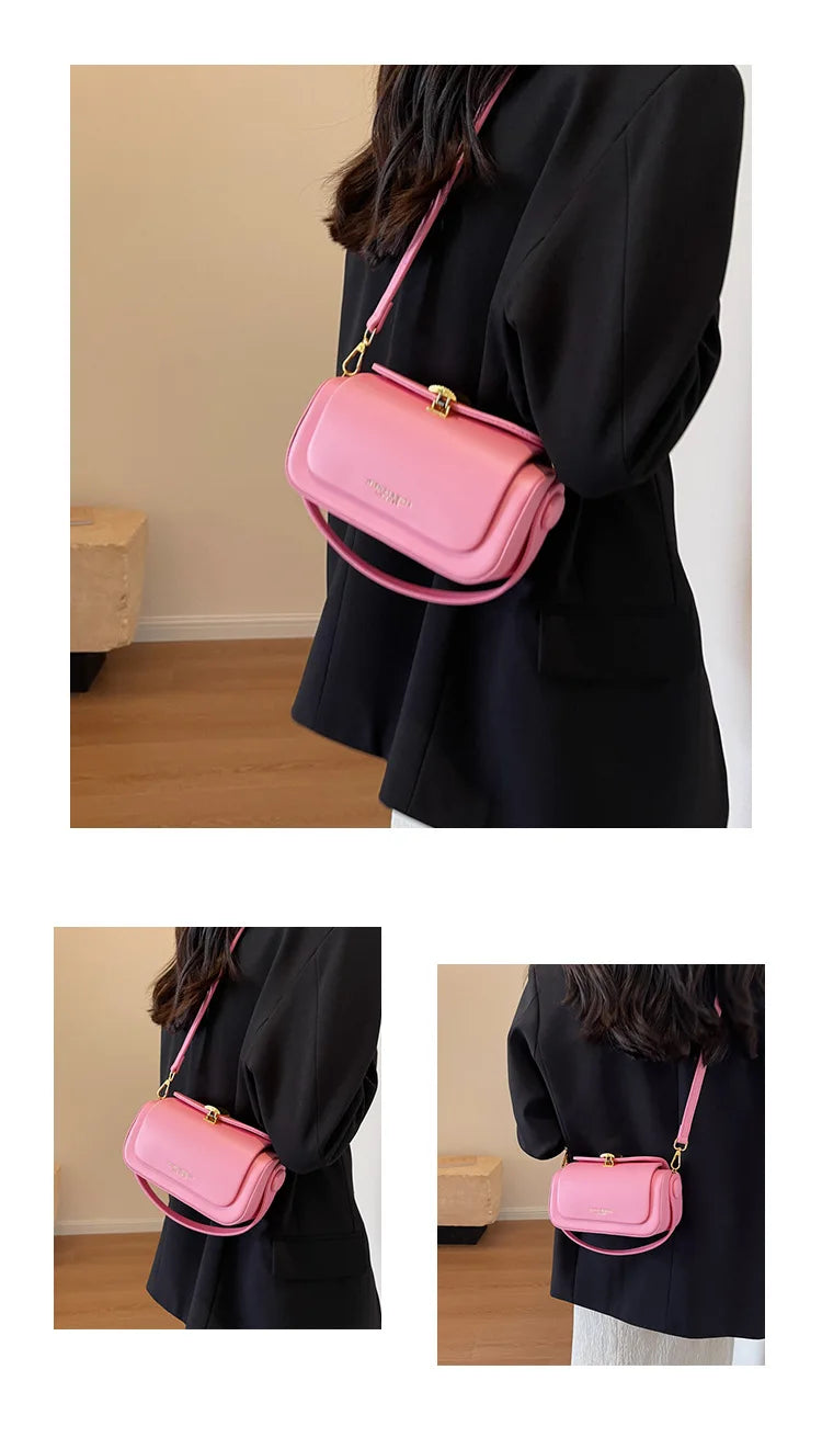 A pink retro textured leather shoulder bag carried by a person in a black coat.