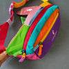 A colorful patchwork fanny pack featuring stripes of pink, green, blue, orange, and purple.