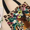 A canvas tote bag featuring a detailed illustration of a tiger wreath and floral elements in earthy tones.