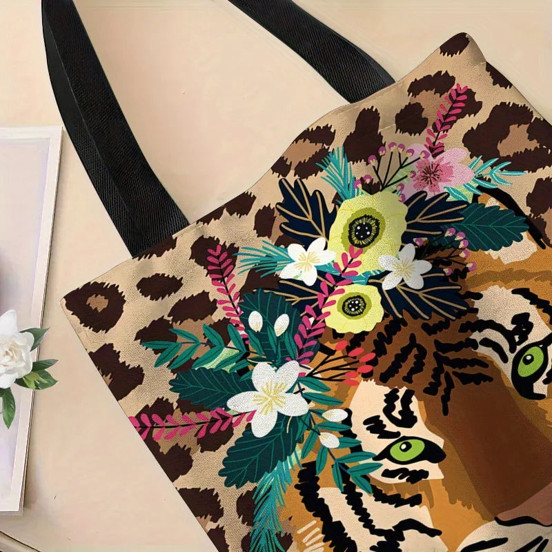 A canvas tote bag featuring a detailed illustration of a tiger wreath and floral elements in earthy tones.