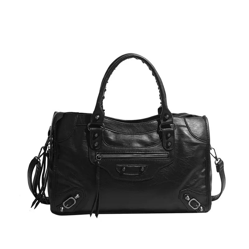 Black saddle-shaped PU leather city tote bag with a flap closure and chain strap.