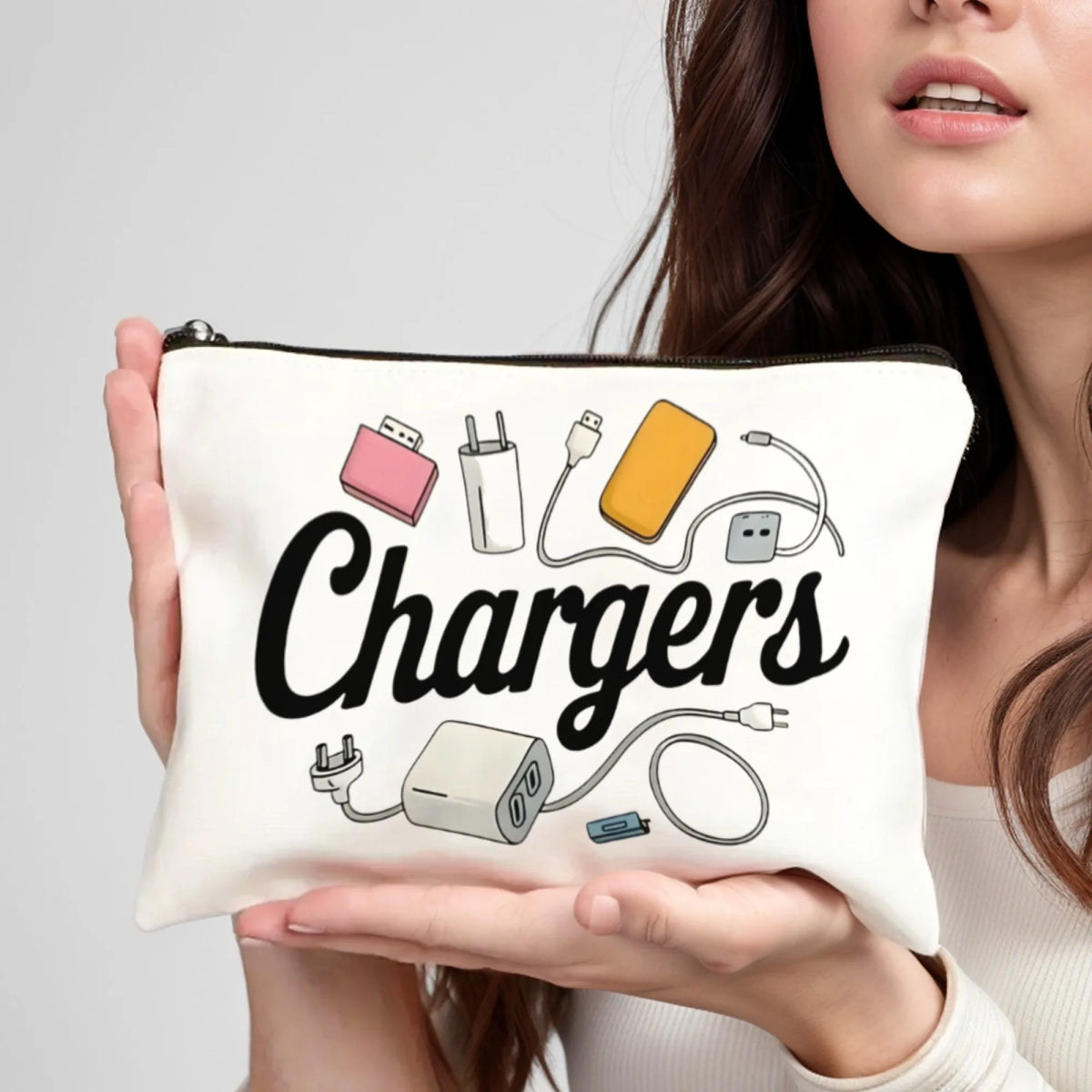 A white pouch with the word Chargers printed on it is held by a person.