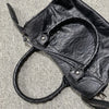 A black soft PU leather shoulder tote bag with a leather drawstring detail is shown against a light gray background.