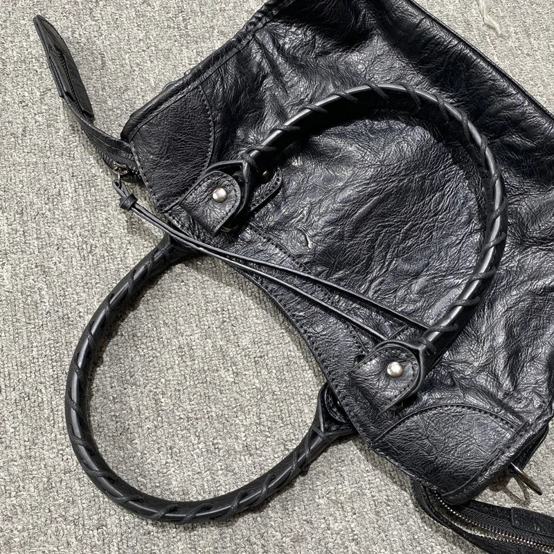 A black soft PU leather shoulder tote bag with a leather drawstring detail is shown against a light gray background.