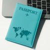 A teal leather passport holder with a world map design resting on a white surface next to a laptop.
