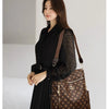 A woman models a brown leather backpack with gold hardware against a light background.