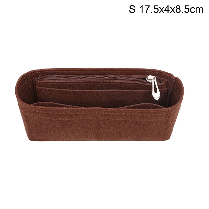 A brown felt bag insert organizer with a zipper closure and a small metal charm.