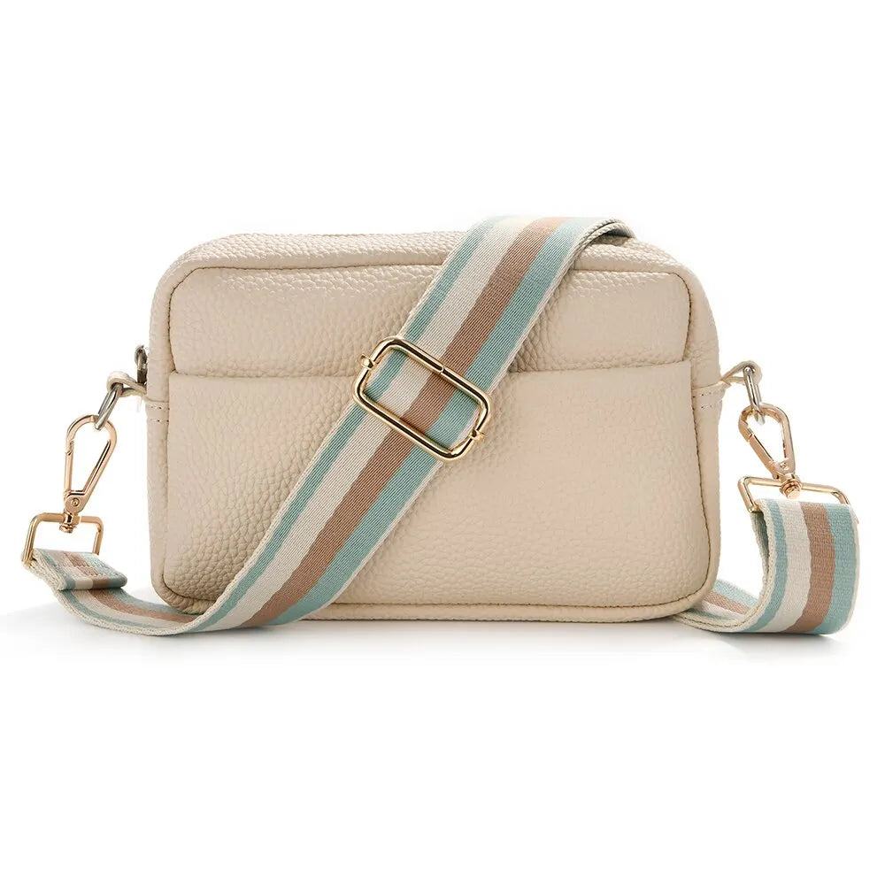 A beige nylon crossbody bag with a striped tan and light blue strap.