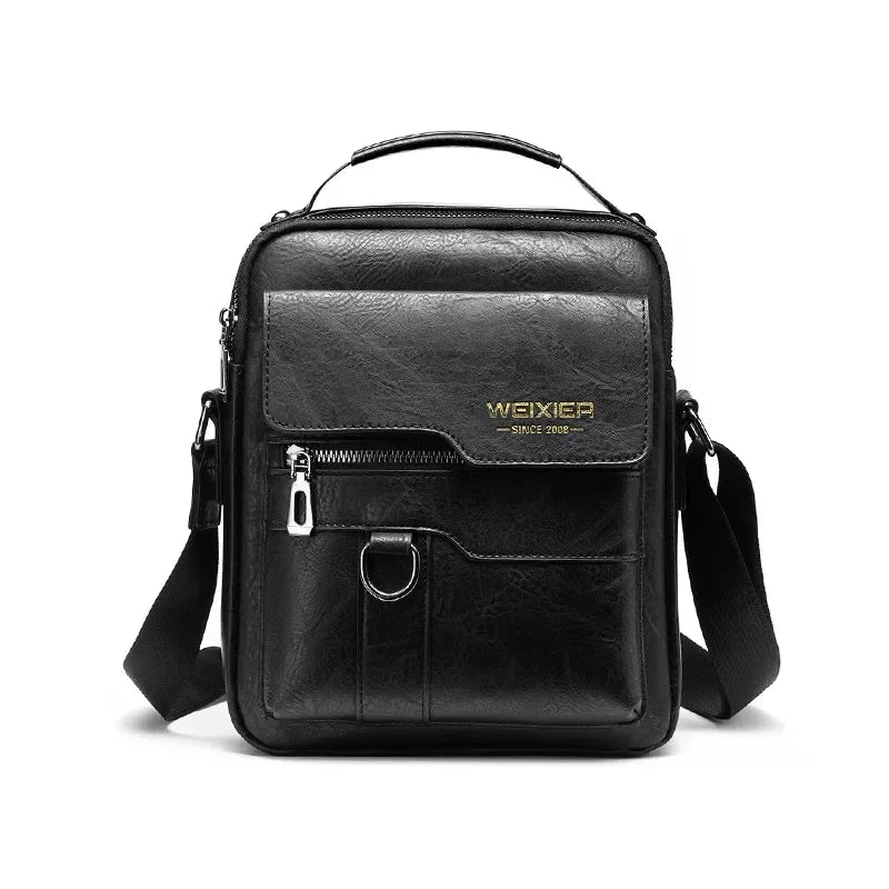 Black leather crossbody messenger bag with gold lettering and adjustable strap.