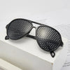 A pair of black precision vision correction glasses resting on a white surface.