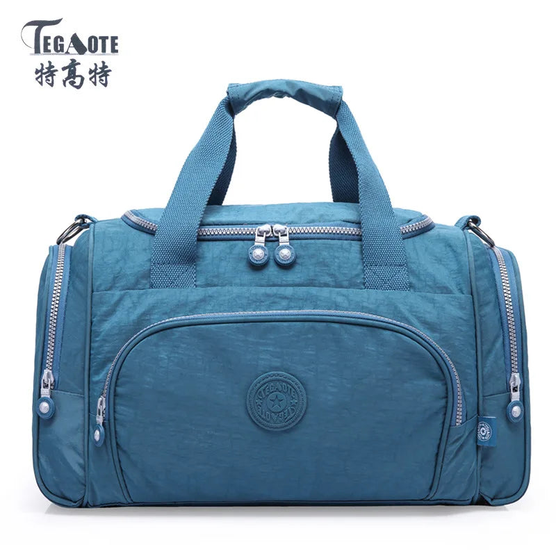 A teal nylon travel duffle bag with handles and zippers is shown against a white background.