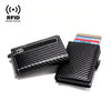 A black slim wallet made of carbon fiber material with a zippered compartment and a stack of cards.