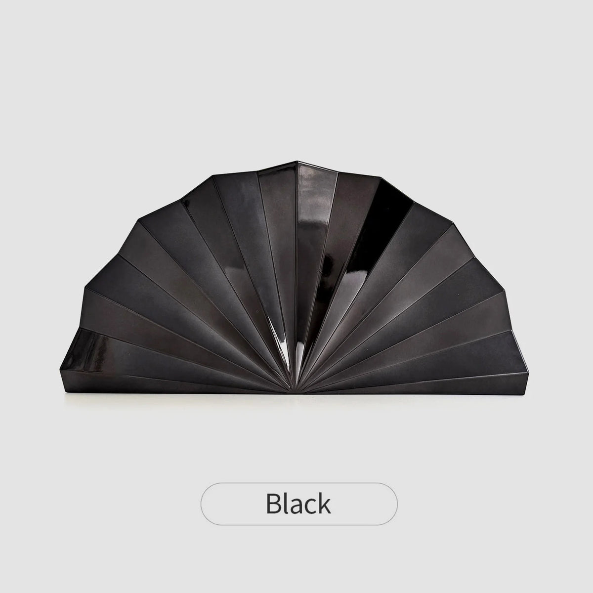A black gold acrylic chain crossbody bag shown in a fan or pleated style.