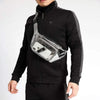 A person wearing a black zip-up jacket with a clear waterproof transparent fanny pack attached.