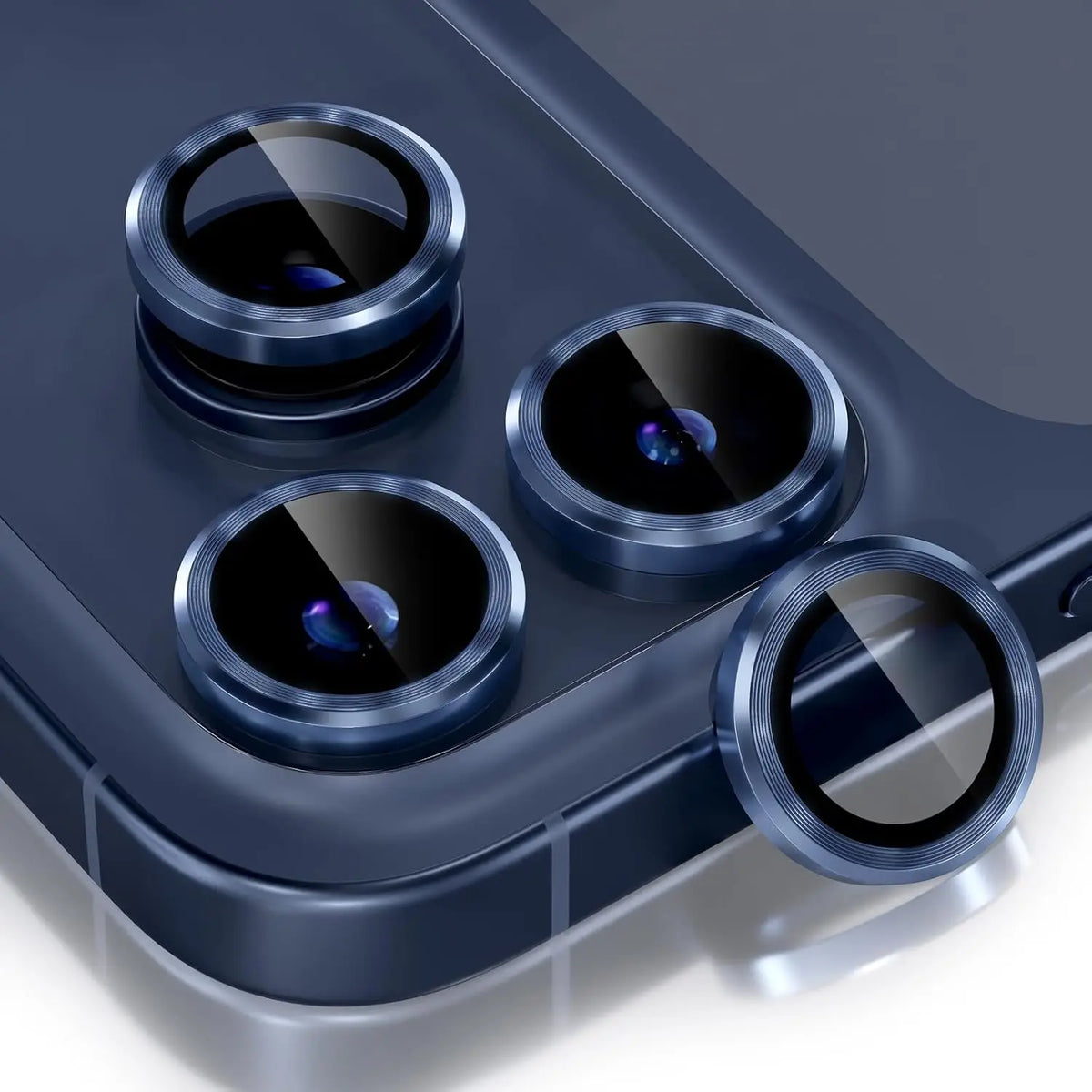 A close-up view of a glitter diamond camera lens protector with a metal frame for an iPhone, showing multiple lenses.