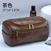 A brown leather toiletry bag with a zippered compartment and brass clasps is shown next to a small glass bottle.