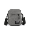 A gray minimalist nylon crossbody bag for men with black strap and buckle.