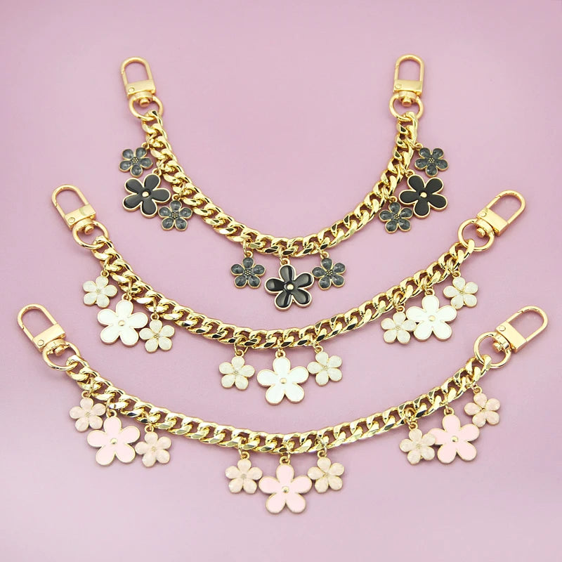 Gold and rose gold layered charm extension necklace featuring bag flower pearl charms