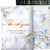 White poly mailers with gold marble patterns and thank you text for small business packaging