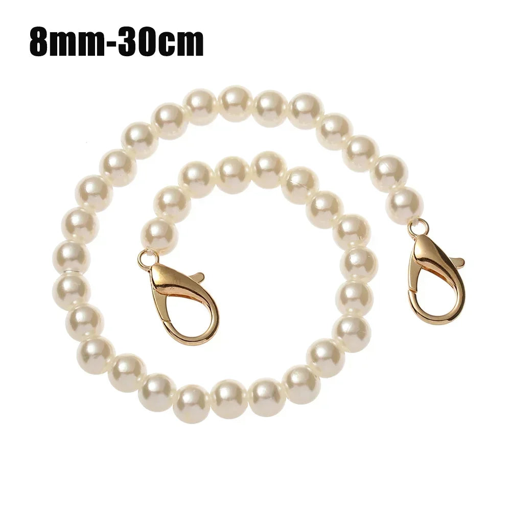 A strand of small, round white pearls used as a strap for a handbag or purse.