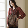 A woman models a brown genuine leather women's backpack with gold hardware.