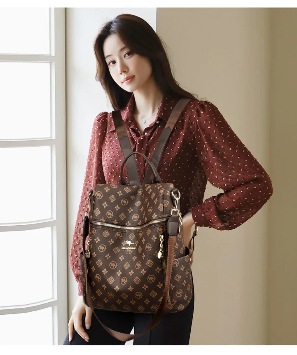 A woman models a brown genuine leather women's backpack with gold hardware.