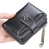 A black PU leather compact wallet with a flap closure and a gold-toned chain is being held by a hand.