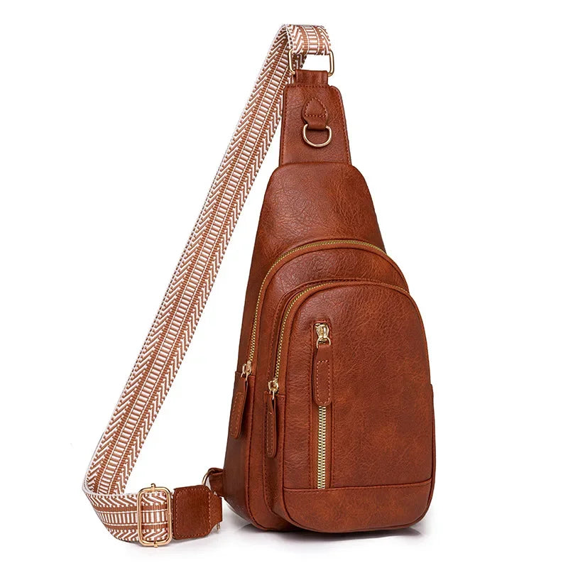 A brown PU leather crossbody sling bag with a patterned strap and gold hardware.