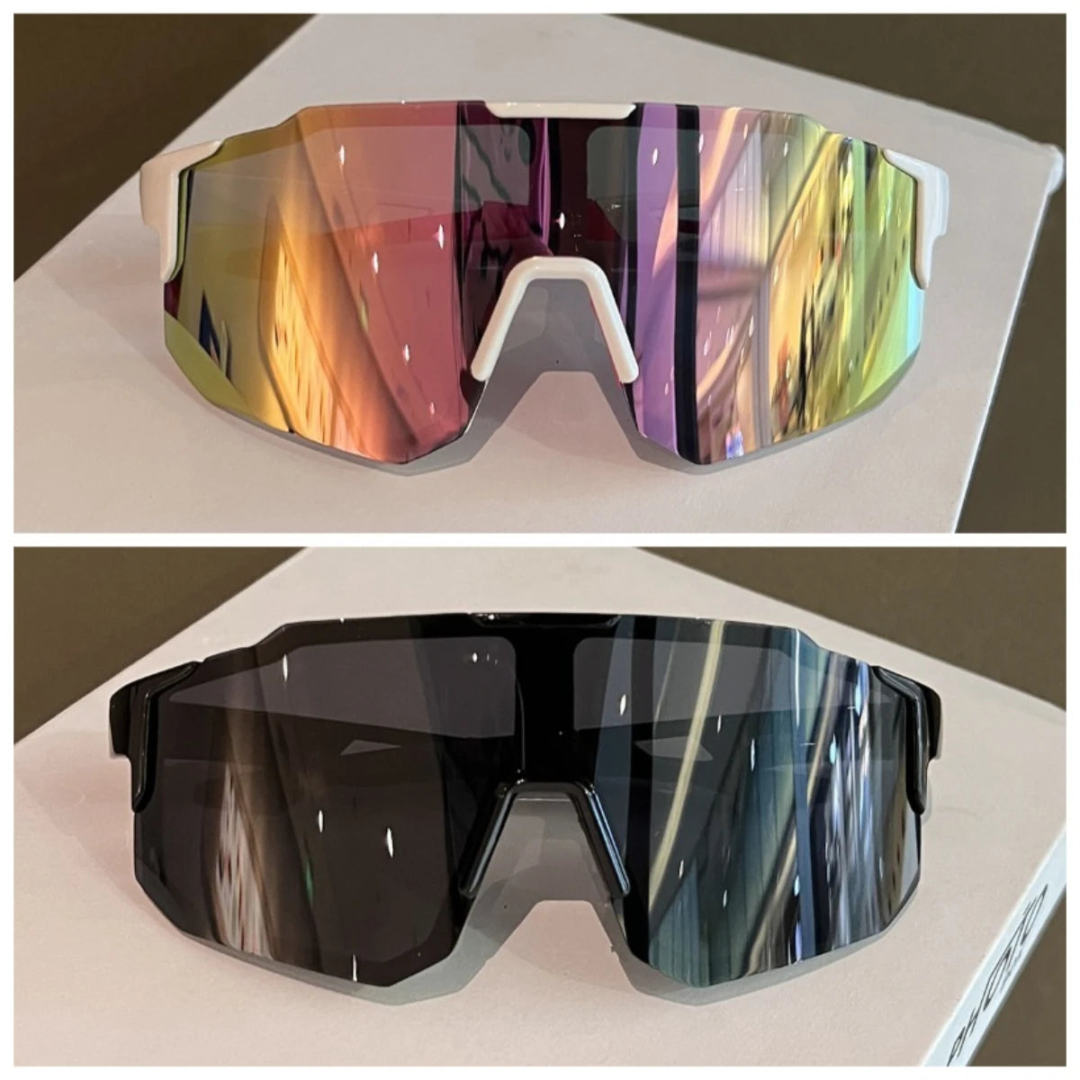 Un par de gafas de ciclismo reflectantes con lente degradado y montura blanca.