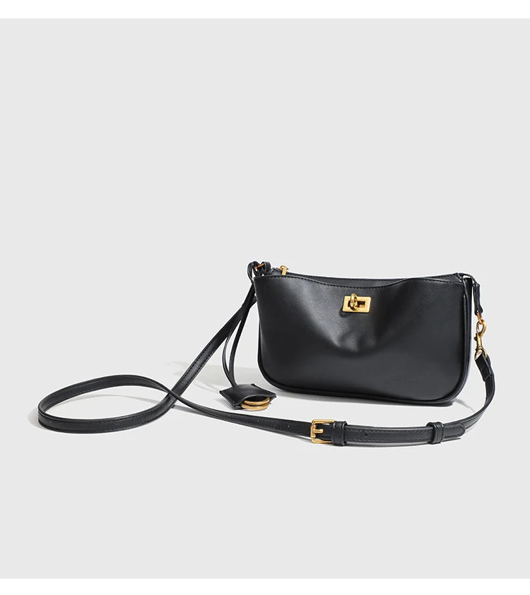A black classic split leather shoulder tote bag with gold hardware and a long strap.