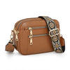 A brown PU leather crossbody bag with gold zippers and a patterned strap is shown against a white background.