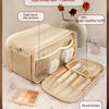 A beige PU leather makeup organizer featuring a right storage layer with three partitions, dual mesh slip pockets, and a brus
