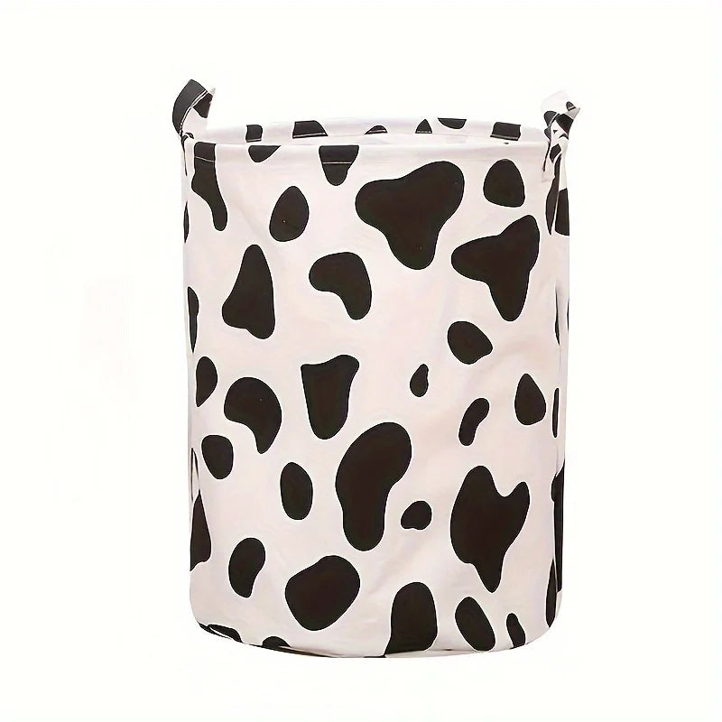 Panier à linge en tissu blanc avec motif vache noire.