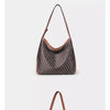 A close-up view of a brown leather geometric embroidery hobo shoulder bag with a long strap.