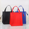Three insulated tote bags in black, red, and blue standing upright on a white surface.