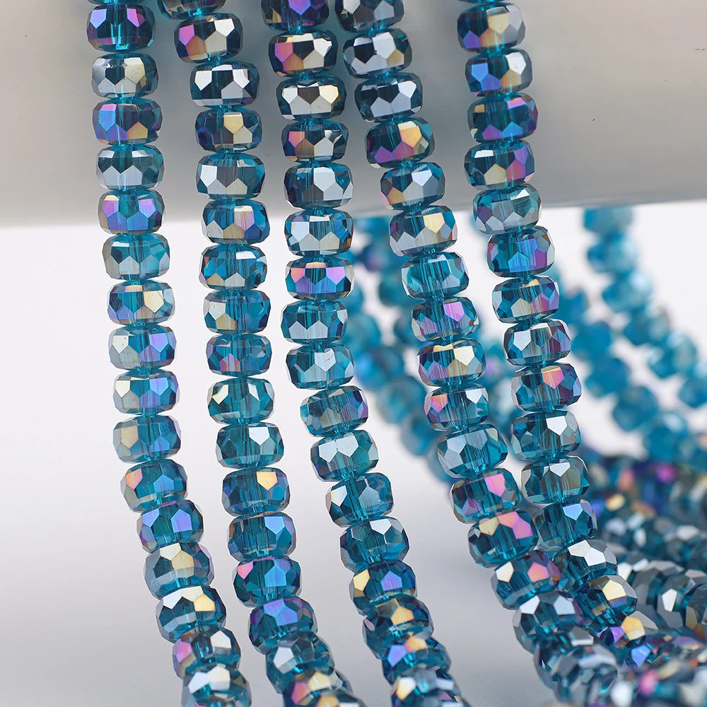 Blue iridescent AB faceted crystal glass beads in a wheel shape strung on a wire.