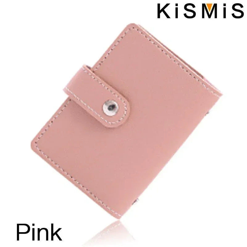 A pink slim leather card holder with a stitched closure is shown against a white background.