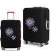 Black rolling suitcase with purple floral embroidery and a pink handle.