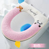 A pink plush waterproof toilet seat cover with a teddy bear and panda design